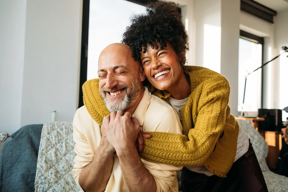 A couple sharing a warm, laughing embrace