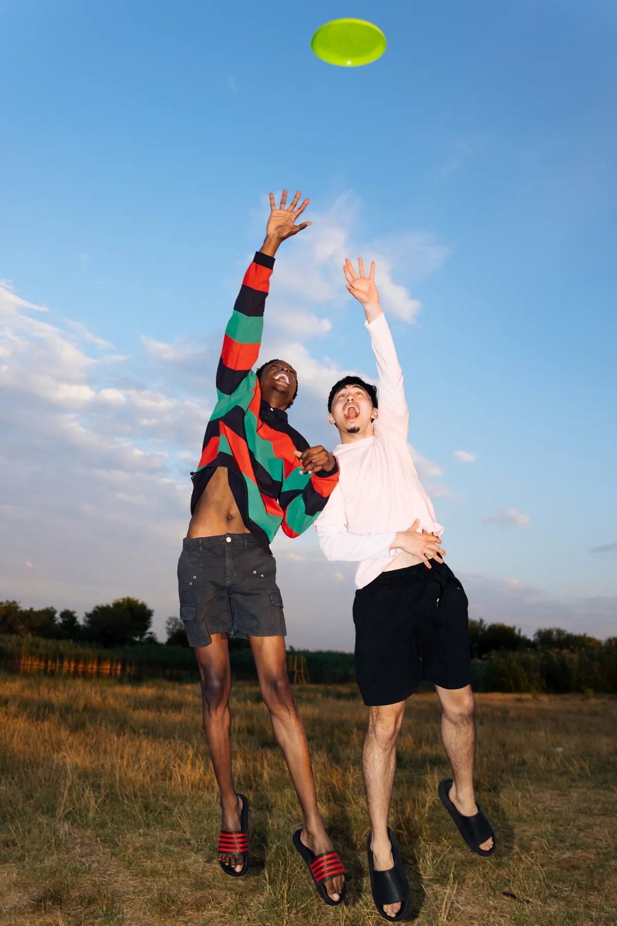 Two friends playing with a frisbee outdoors